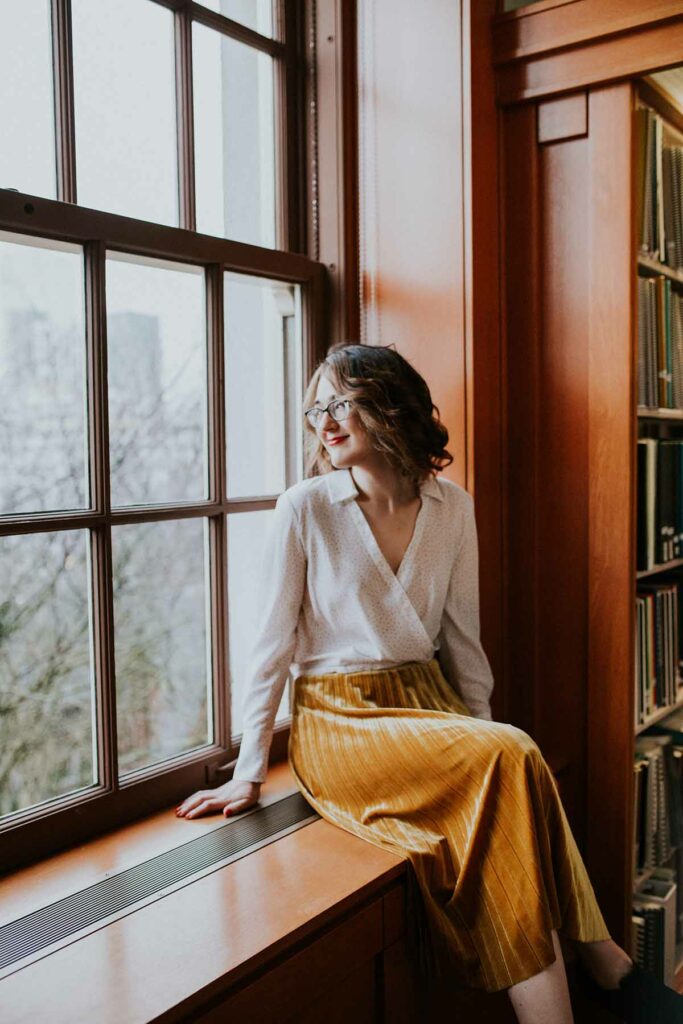 Woman sitting at a window in fancy clothes