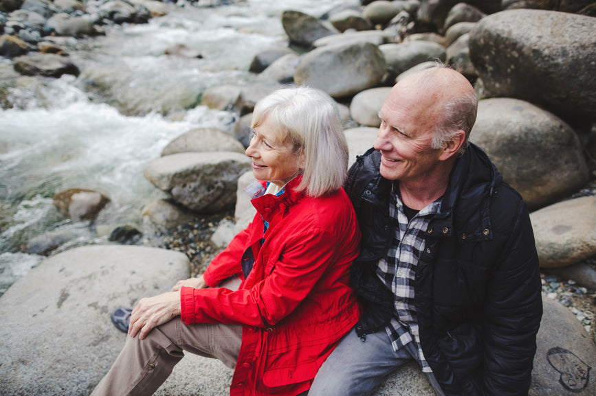 Senior couple posing at a river