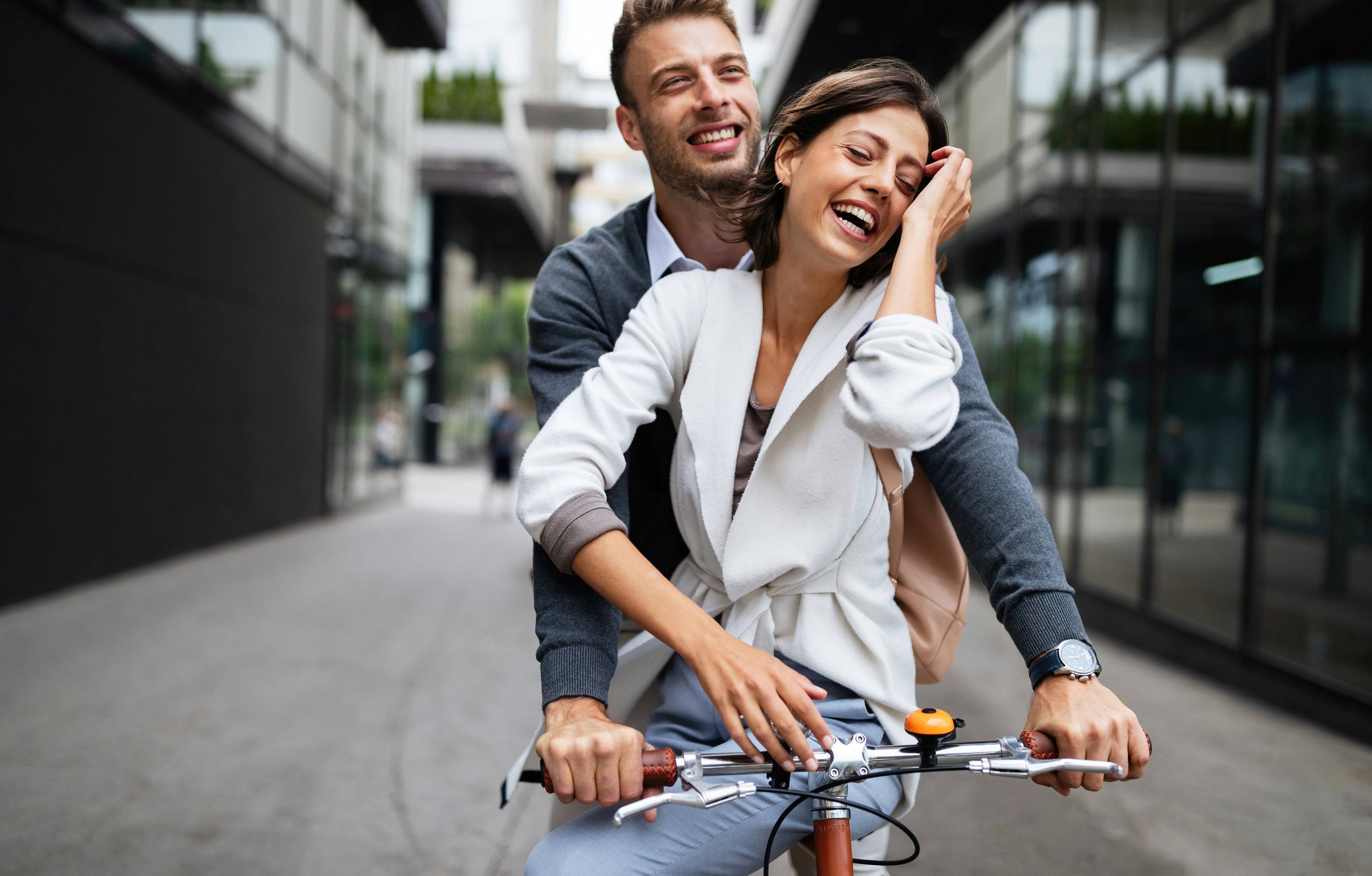 Getty Images Couple together on a single bike riding through town