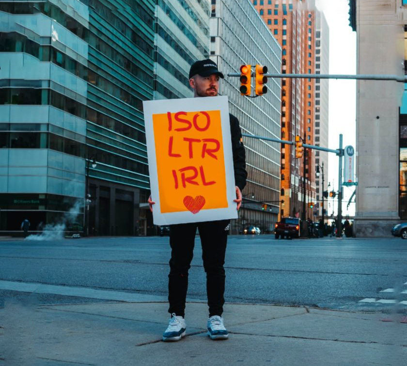 Man in New York holding acronym sign