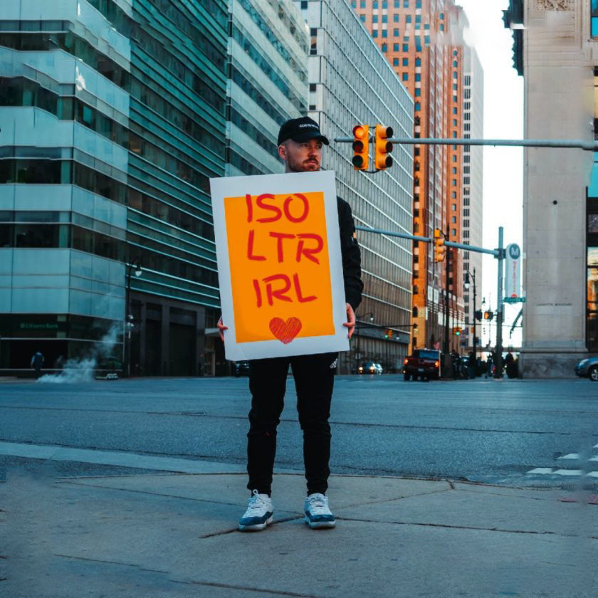 Man in New York holding acronym sign