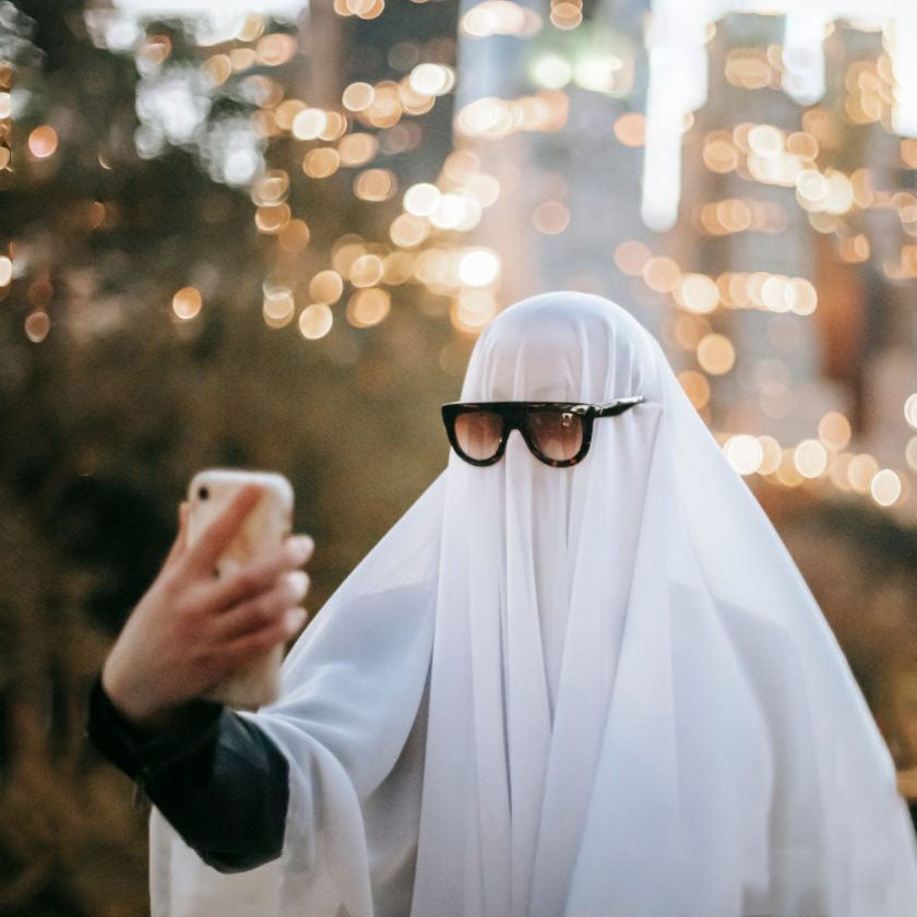 Man in a ghost costume taking a selfie