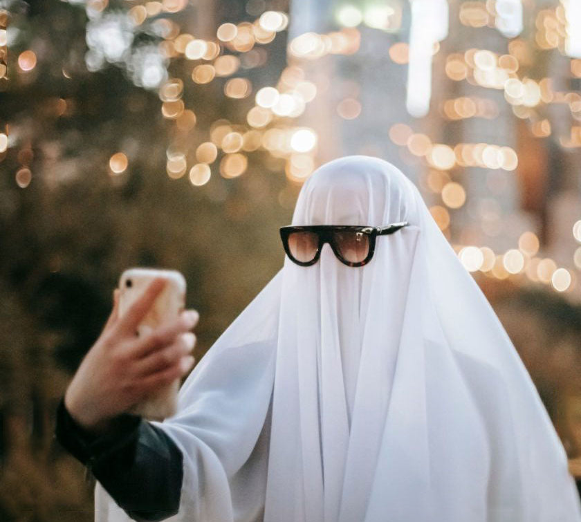 Man in a ghost costume taking a selfie