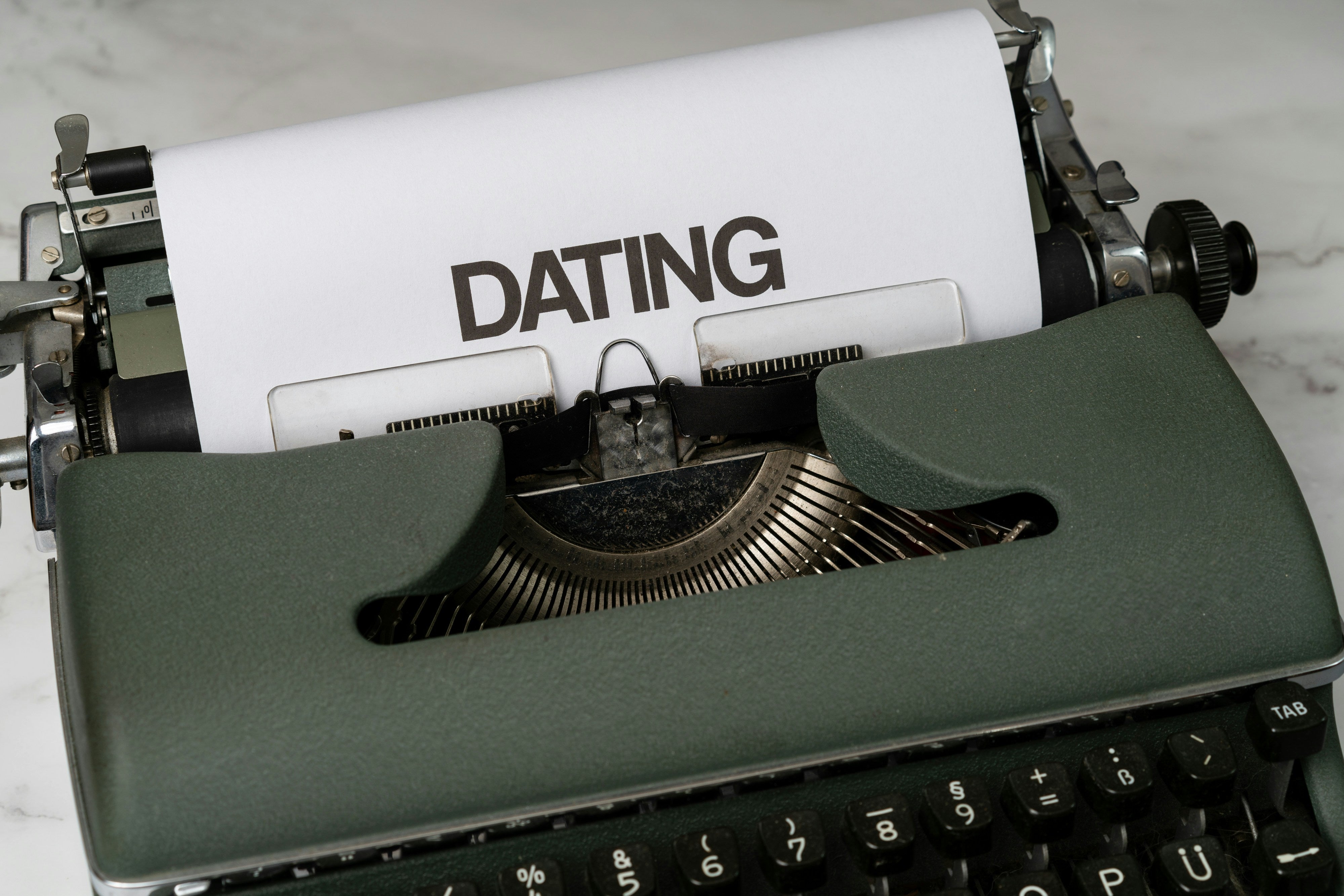 a close up of a typewriter with a paper on it