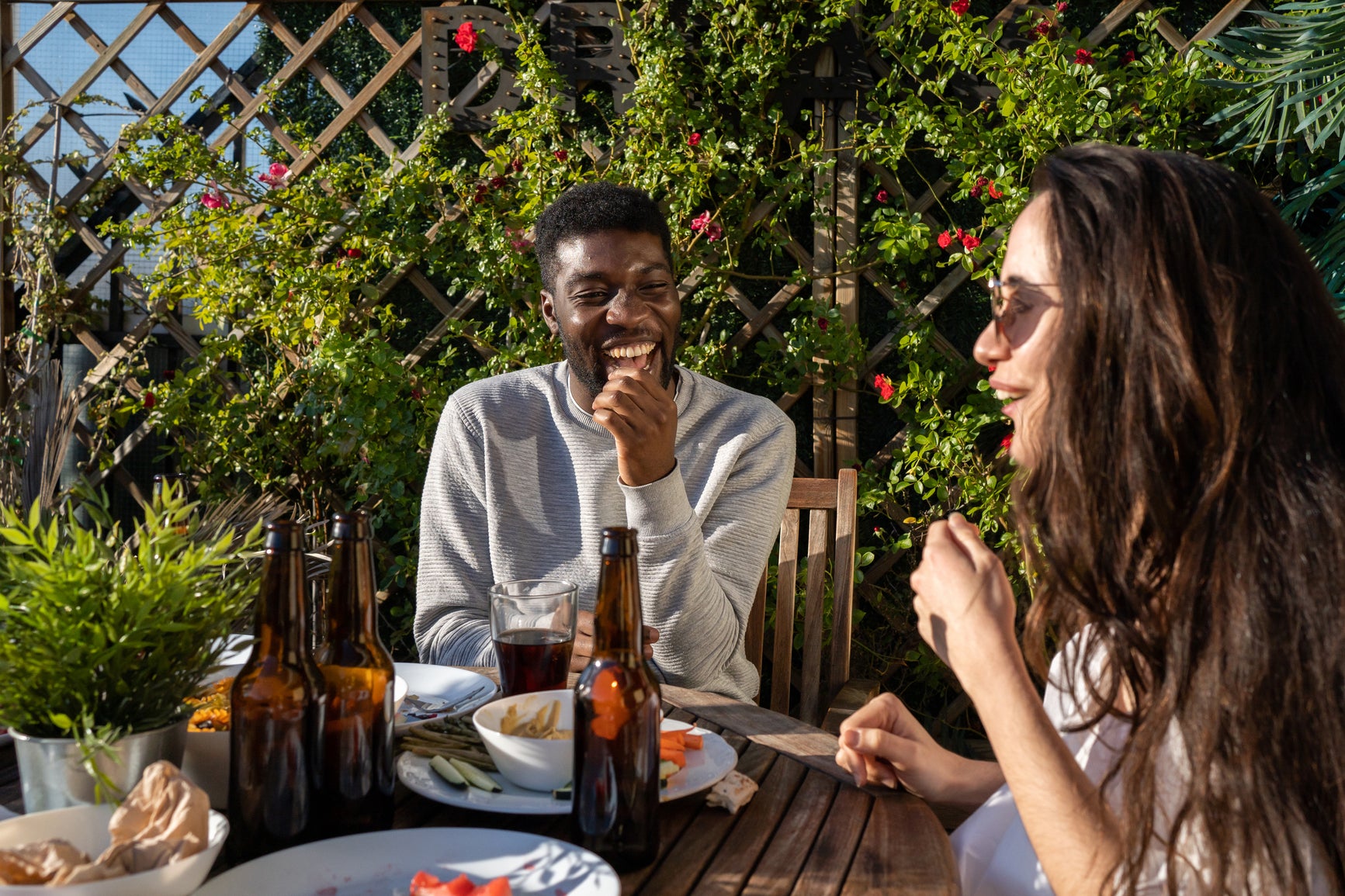 Mixed race couple eating lunch in a garden