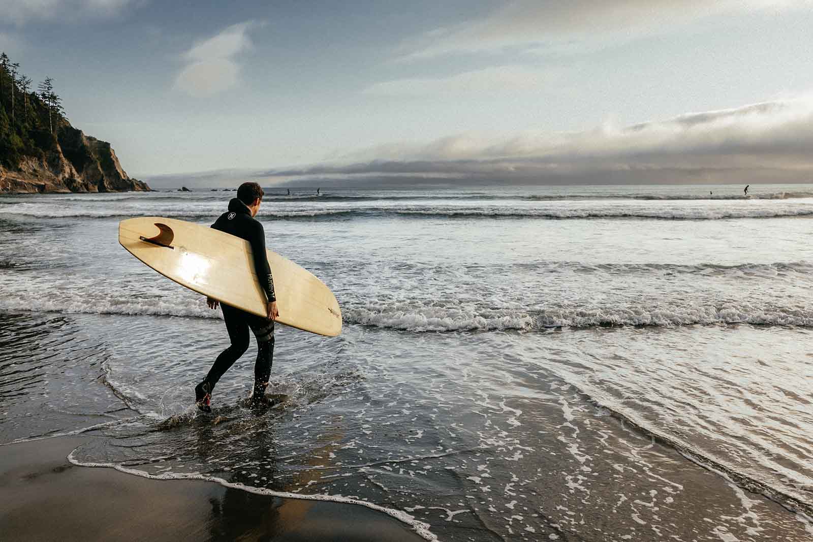 Man with a surfboard on the beach