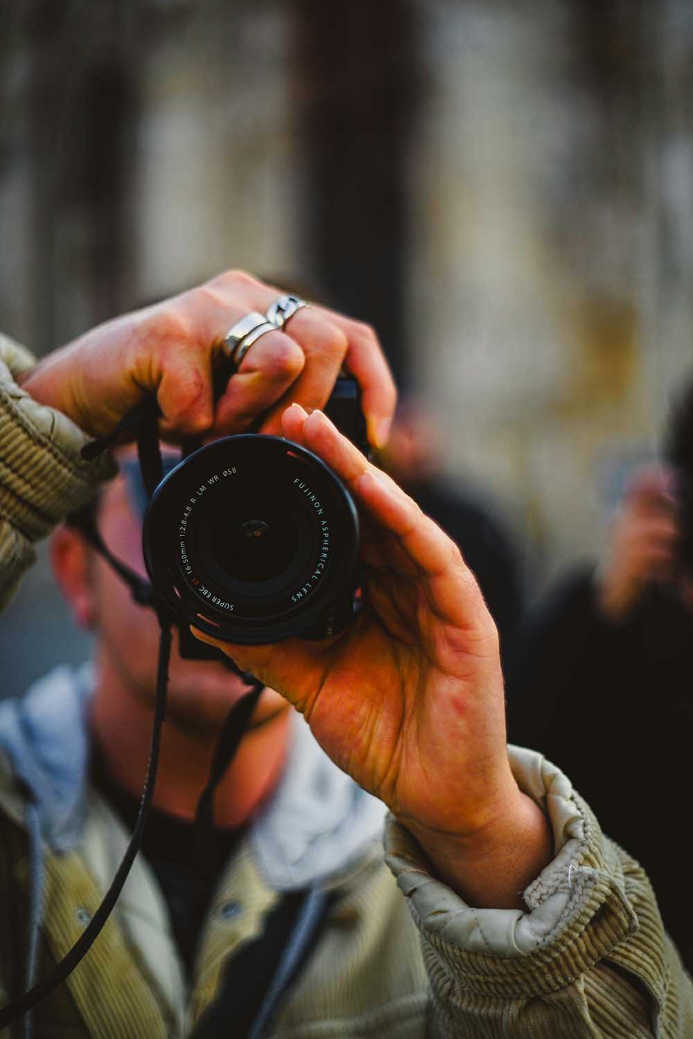 Man holding a camera outside