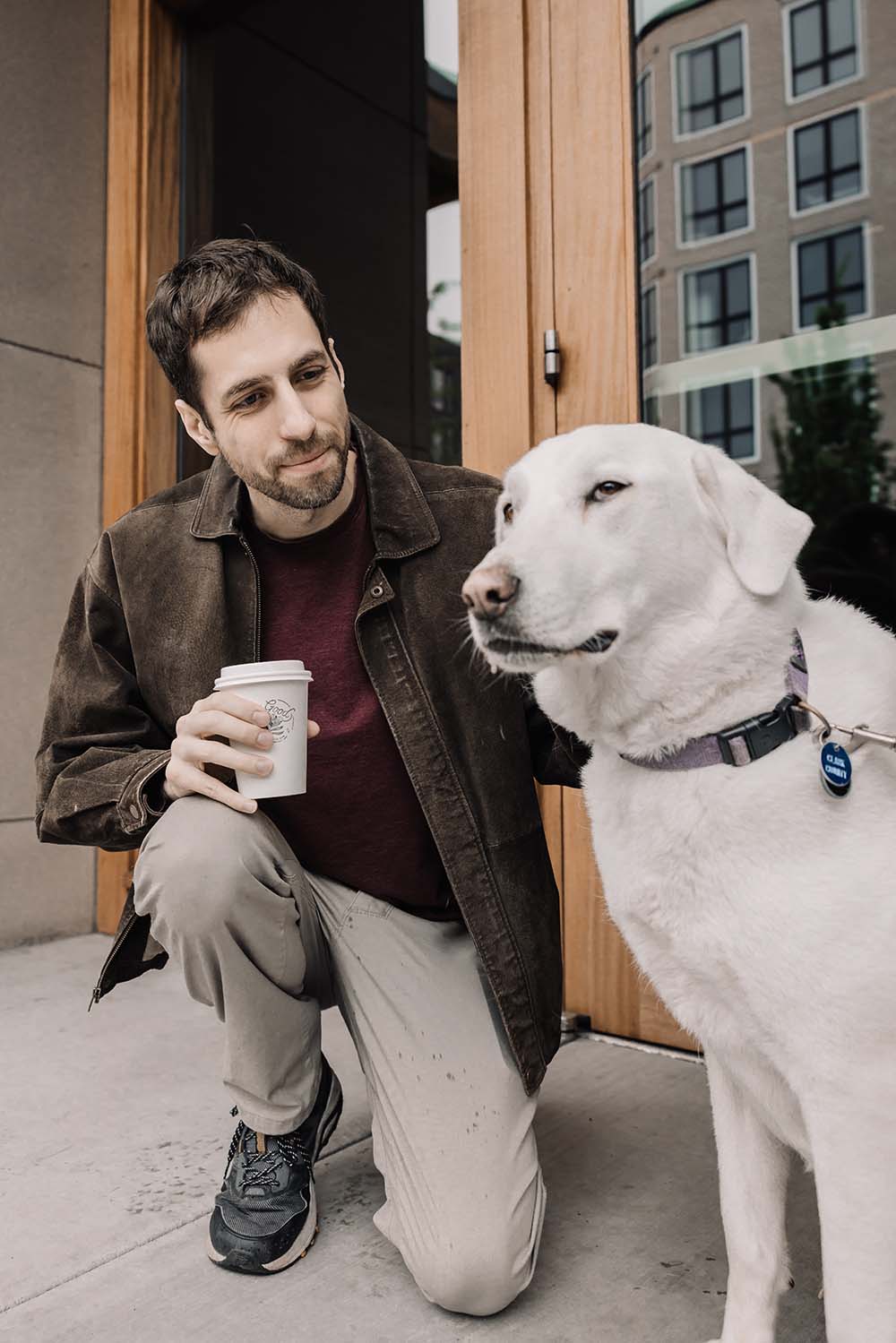 Man with a dog outside a store