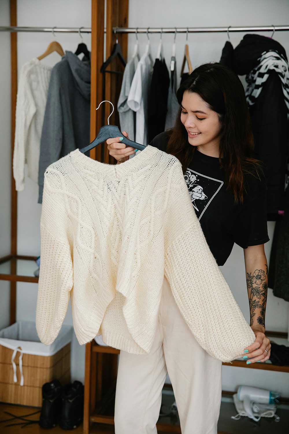 Woman holding a white sweater at a shop