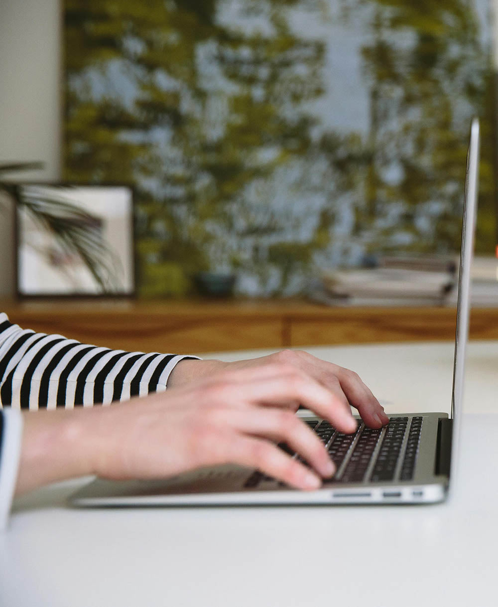 Young woman typing at a laptop