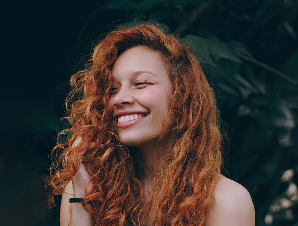 Pretty red headed woman smiling