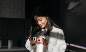 asian woman looking at her phone