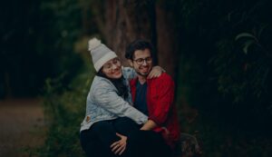 couple hugging in the woods