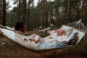 two people in a hammock in the woods